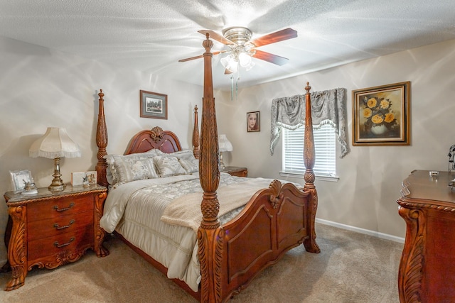 bedroom with a textured ceiling, ceiling fan, and light carpet