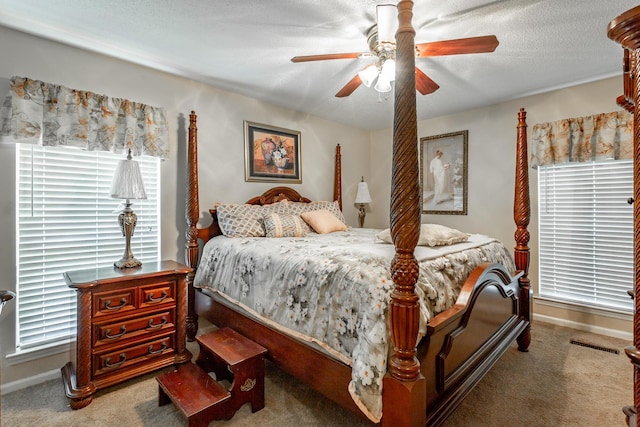 carpeted bedroom with a textured ceiling and ceiling fan