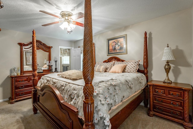 carpeted bedroom with ceiling fan and a textured ceiling