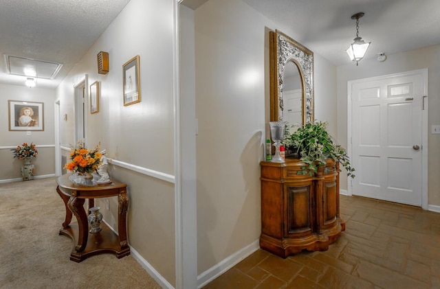 entryway featuring a textured ceiling and dark carpet