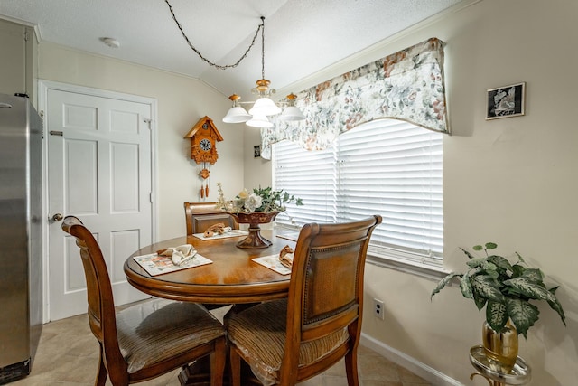 tiled dining room featuring a notable chandelier