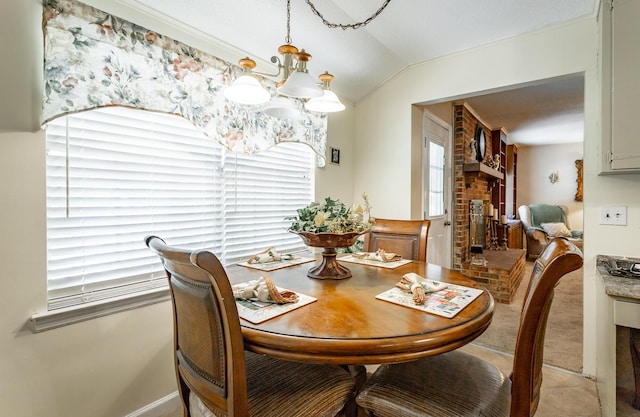 dining space with an inviting chandelier, plenty of natural light, and lofted ceiling