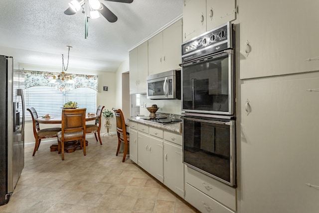 kitchen featuring white cabinets, ceiling fan with notable chandelier, hanging light fixtures, a textured ceiling, and stainless steel appliances