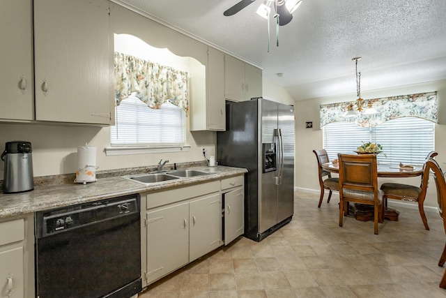 kitchen featuring pendant lighting, dishwasher, ceiling fan with notable chandelier, sink, and stainless steel fridge with ice dispenser