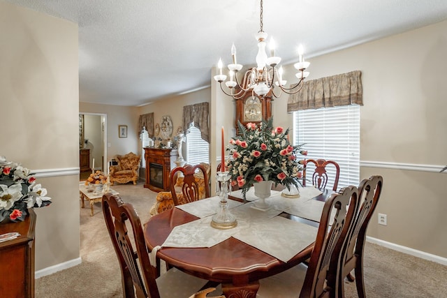 carpeted dining area featuring a chandelier