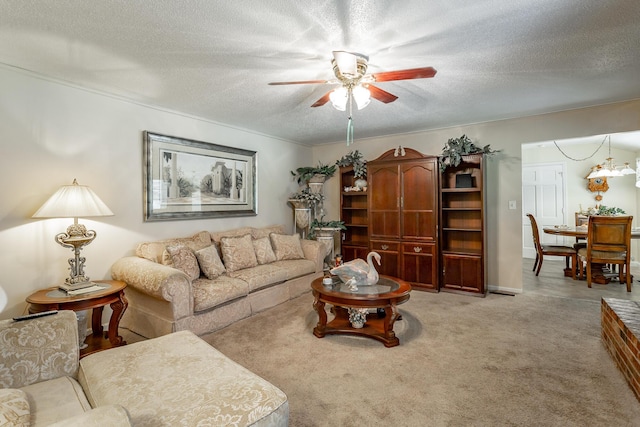 carpeted living room featuring a textured ceiling and ceiling fan