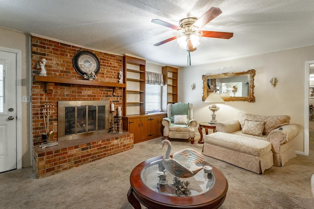 living room featuring ceiling fan, carpet floors, a textured ceiling, and a brick fireplace