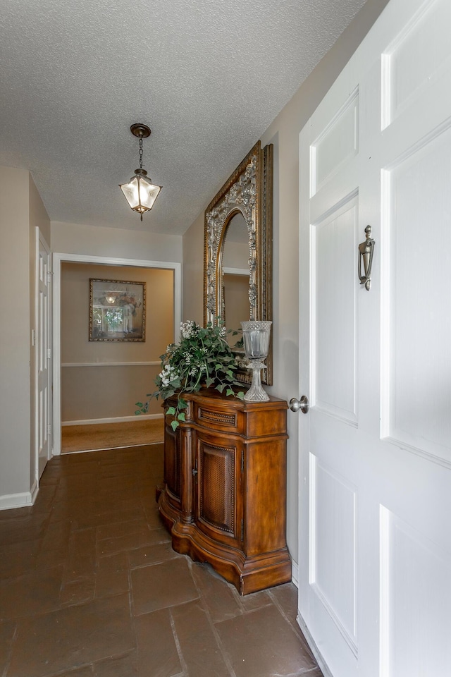 entryway featuring a textured ceiling