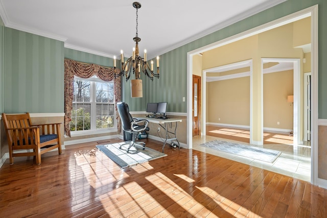 home office with an inviting chandelier, ornamental molding, and hardwood / wood-style flooring