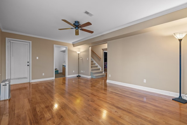 unfurnished living room with ceiling fan, wood-type flooring, and crown molding