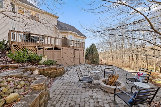 view of patio featuring a fire pit and a wooden deck