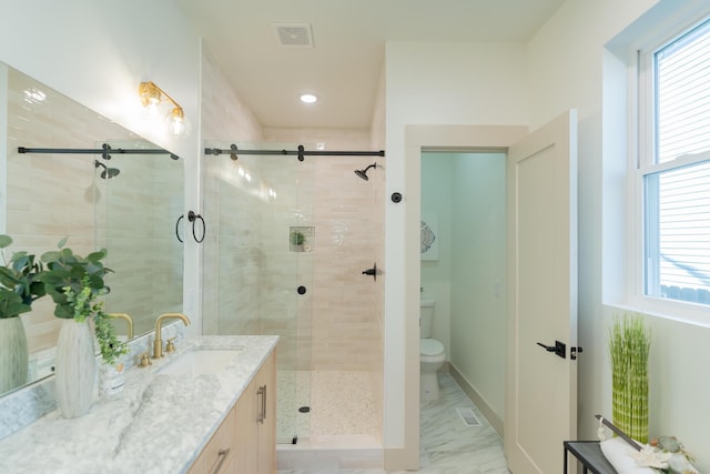 bathroom featuring vanity, toilet, and an enclosed shower