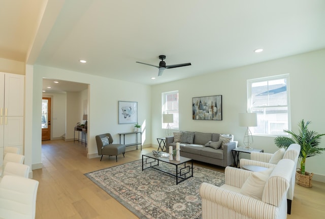 living room with ceiling fan and light hardwood / wood-style floors