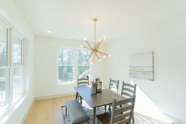 dining area featuring a notable chandelier and light hardwood / wood-style flooring