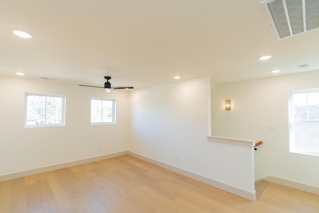 spare room with hardwood / wood-style flooring and ceiling fan