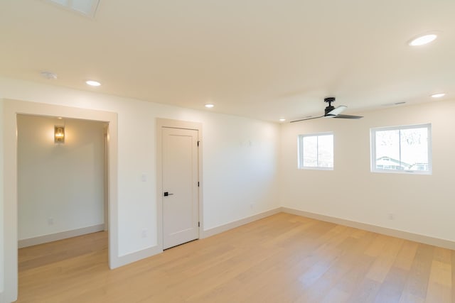 unfurnished room with ceiling fan and light wood-type flooring