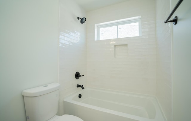 bathroom with shower / bathing tub combination and toilet