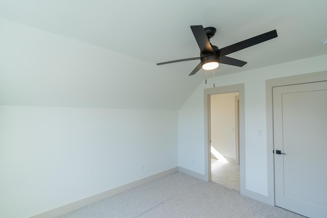 additional living space with ceiling fan, carpet floors, and vaulted ceiling