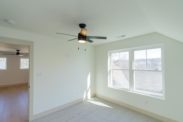 spare room with vaulted ceiling and ceiling fan