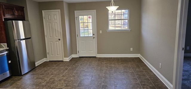 doorway featuring baseboards