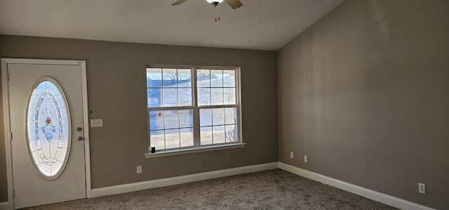 carpeted entrance foyer featuring baseboards, plenty of natural light, and ceiling fan