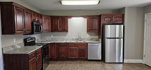 114 Mallard Ln, Lafayette, GA 30728 - kitchen featuring appliances with stainless steel finishes, a sink, light countertops, baseboards, and tile patterned flooring