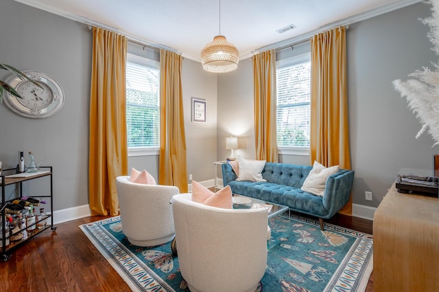 living area with ornamental molding, dark wood-type flooring, and a wealth of natural light