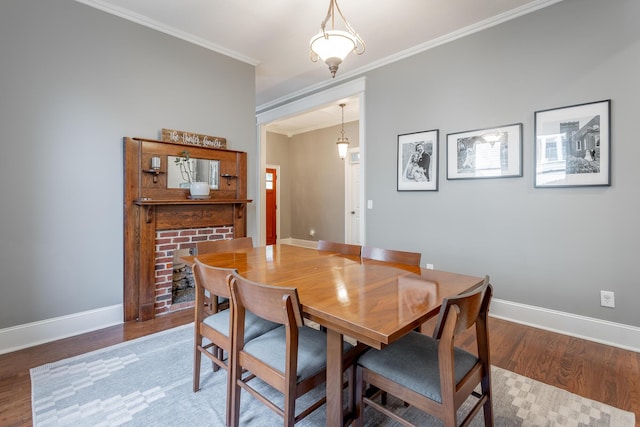 dining room featuring hardwood / wood-style floors and crown molding