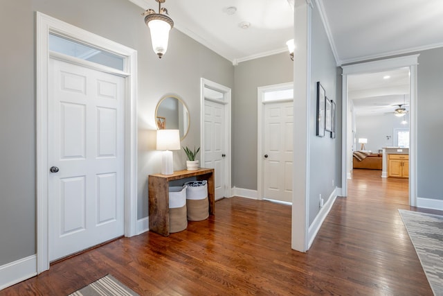 entryway with dark hardwood / wood-style floors, ceiling fan, and ornamental molding