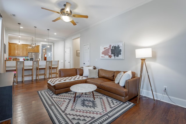 living room with dark wood-type flooring, ceiling fan, and crown molding