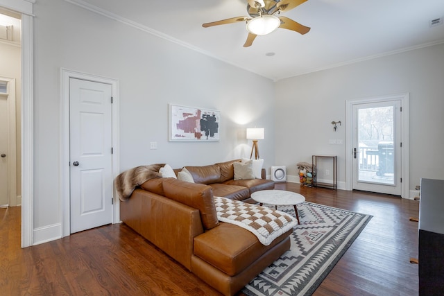 living room with dark hardwood / wood-style floors, ceiling fan, and crown molding