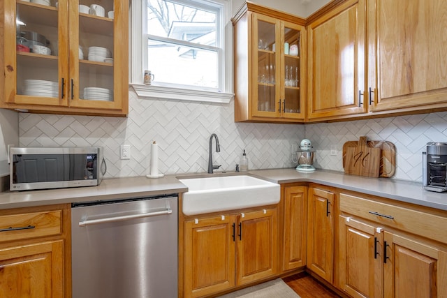 kitchen featuring appliances with stainless steel finishes, tasteful backsplash, and sink