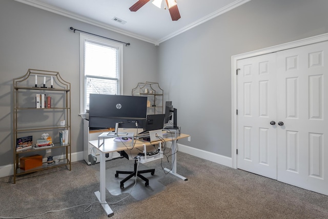 office space featuring dark colored carpet, ceiling fan, and crown molding