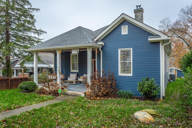 bungalow-style home with a front yard