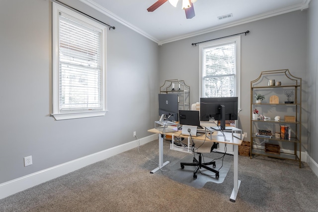 carpeted home office featuring ceiling fan, crown molding, and plenty of natural light