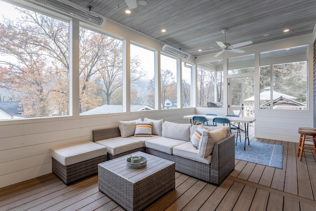 sunroom with ceiling fan, wood ceiling, and a wealth of natural light