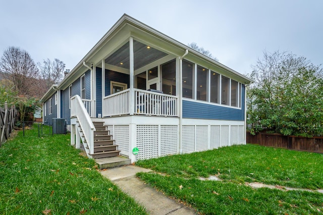 exterior space with a sunroom and a yard