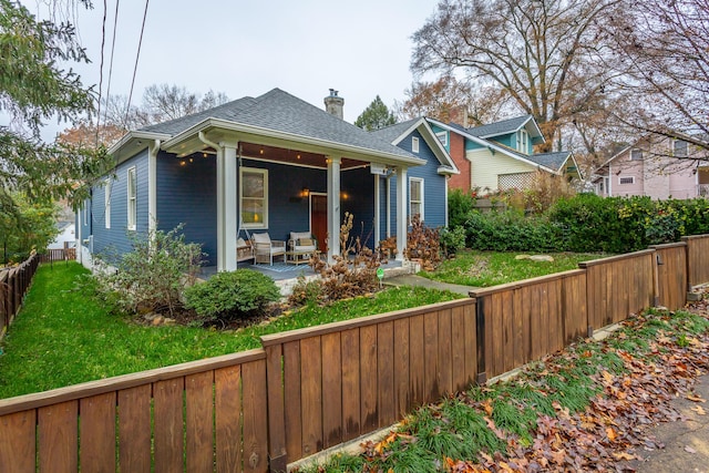 bungalow-style home with a front lawn