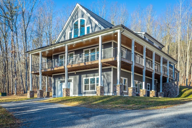 view of front of home with a garage and a balcony