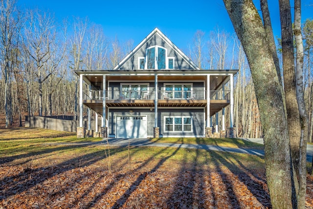 back of house featuring a garage and a lawn