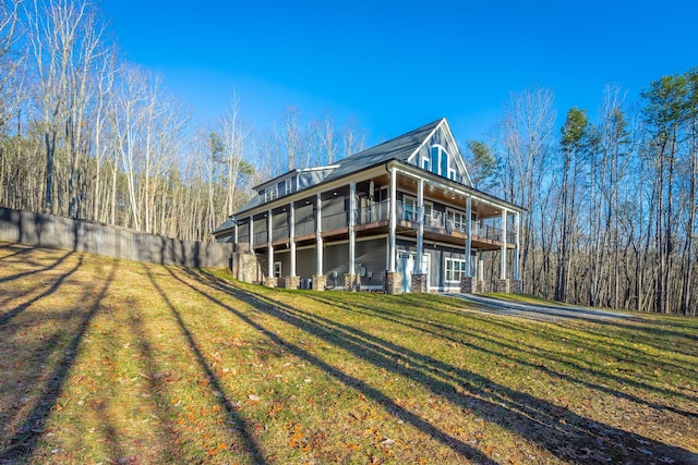 back of property featuring a sunroom and a lawn