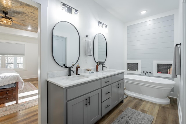 bathroom with vanity, a bathing tub, and hardwood / wood-style floors