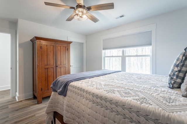 bedroom featuring hardwood / wood-style flooring and ceiling fan