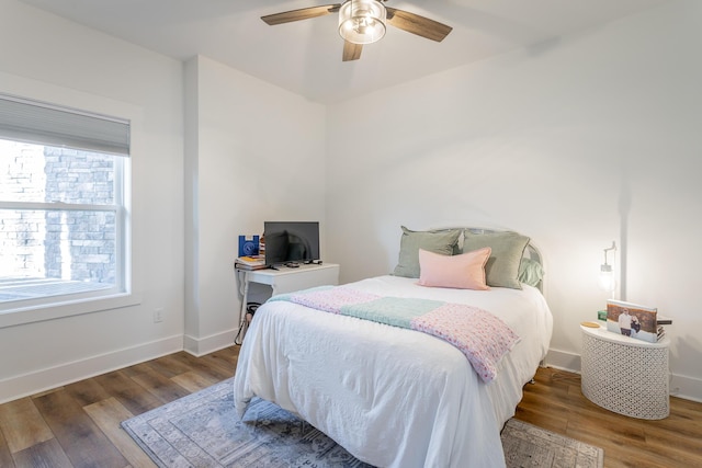 bedroom featuring dark hardwood / wood-style flooring and ceiling fan