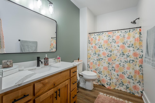 bathroom featuring vanity, hardwood / wood-style floors, and toilet