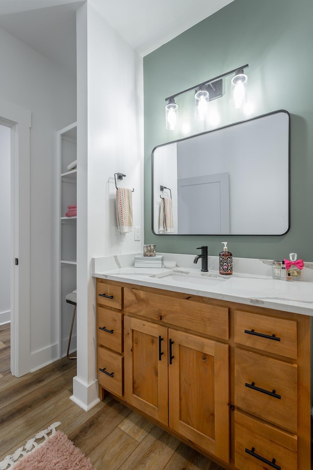 bathroom with hardwood / wood-style flooring and vanity