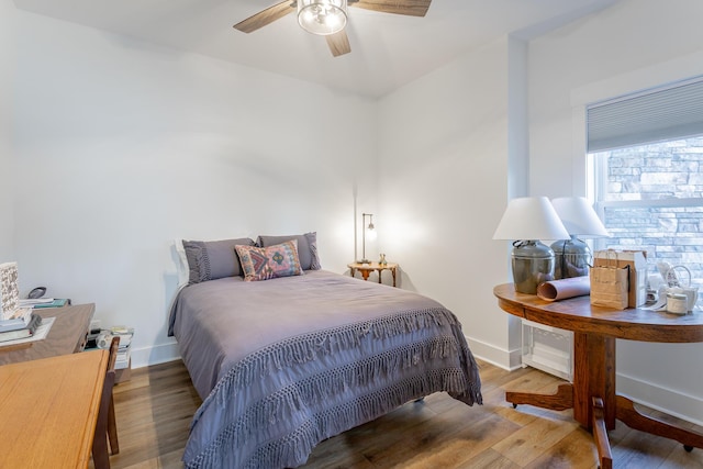 bedroom with wood-type flooring and ceiling fan