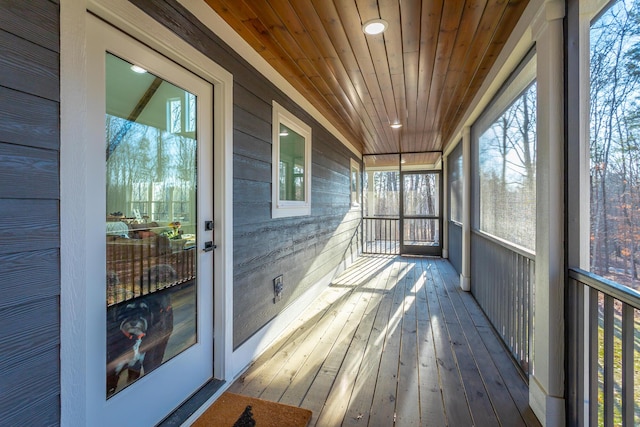 sunroom featuring wood ceiling and a wealth of natural light