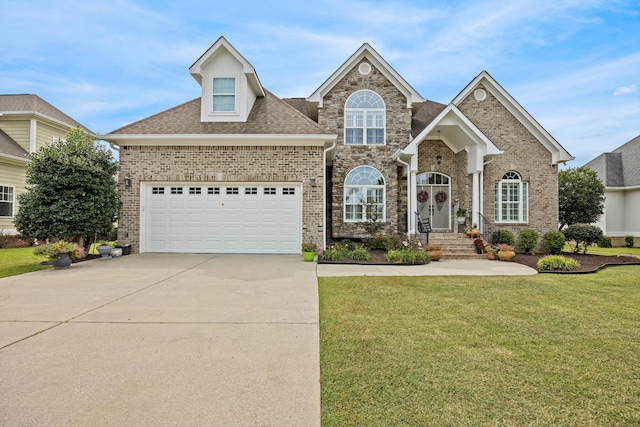 traditional-style house featuring brick siding, a shingled roof, concrete driveway, a garage, and a front lawn