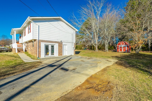 view of home's exterior featuring french doors and a lawn